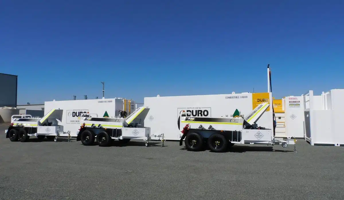 Multiple Durotank DAB trailers lined up at the manufacturing facility alongside self-bunded fuel storage tanks, showcasing Australian-made fuel storage and transport solutions.